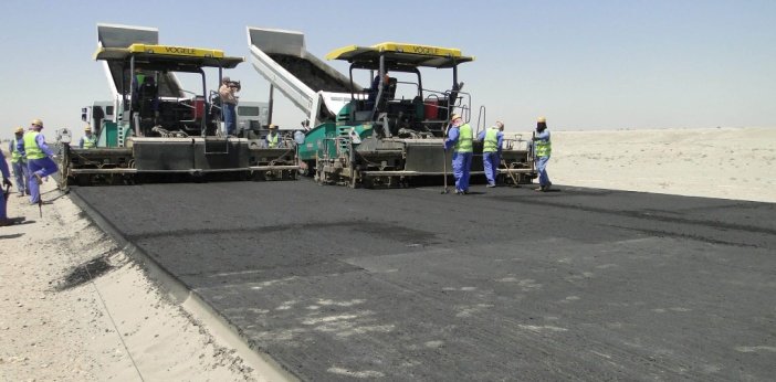 Twin asphalt pavers laying a wide carriageway