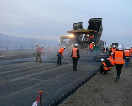 Asphalt paving crew at work behind the paver