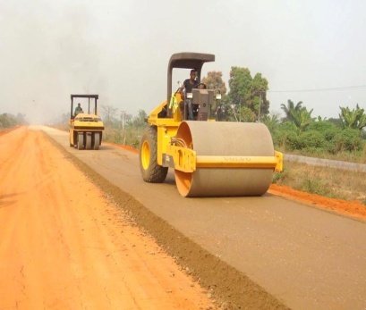 Roller compacting a road base